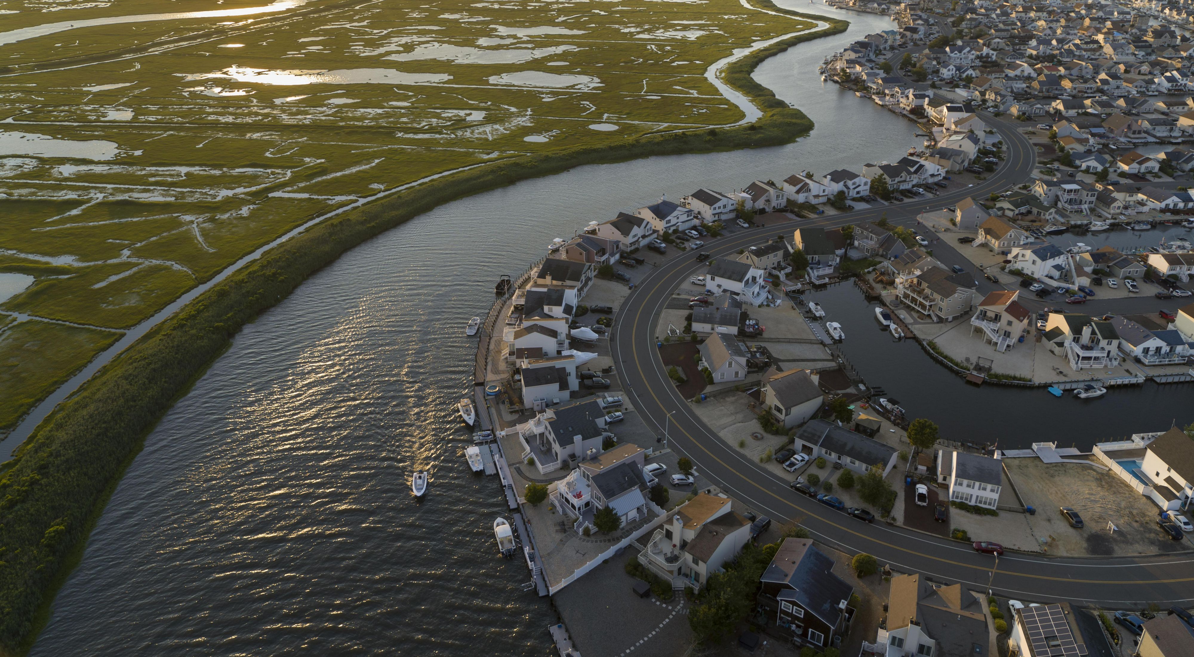 An aerial view of a coastal town surrounded by marsh and water.