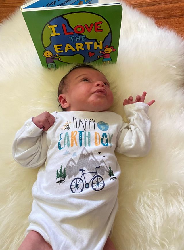 A baby in an Earth Day onesie. 