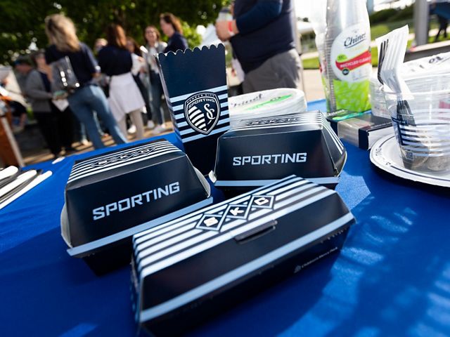 Food containers with the Sporting Kansas City logo and colors. 