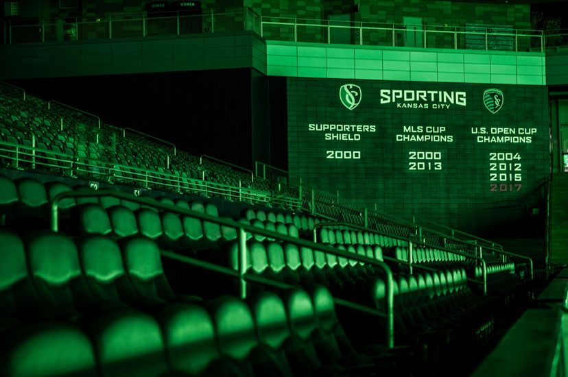 The Sporting Kansas City scoreboard and seats with a green tint over them.