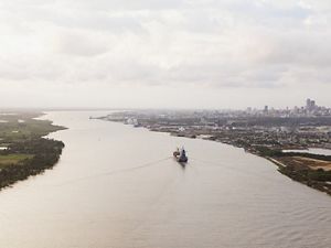 (TNC LICENSE) February 2017. Aerial view of the city of Barranquilla and Magdalena River. Bocas de Ceniza is the mouth of the Magdalena River in the Caribbean Sea. It gets its name from the oceans dusky color. At present, the river flows into the sea through an artificial canal built in the 1930s. Sediments have become a major issue intervening with navigability and  accessibility for ships to enter Barranquilla. Photo credit: © Juan Arredondo   