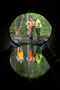 Hadley Couraud and Joshua Royte collecting culvert & stream data in the field.