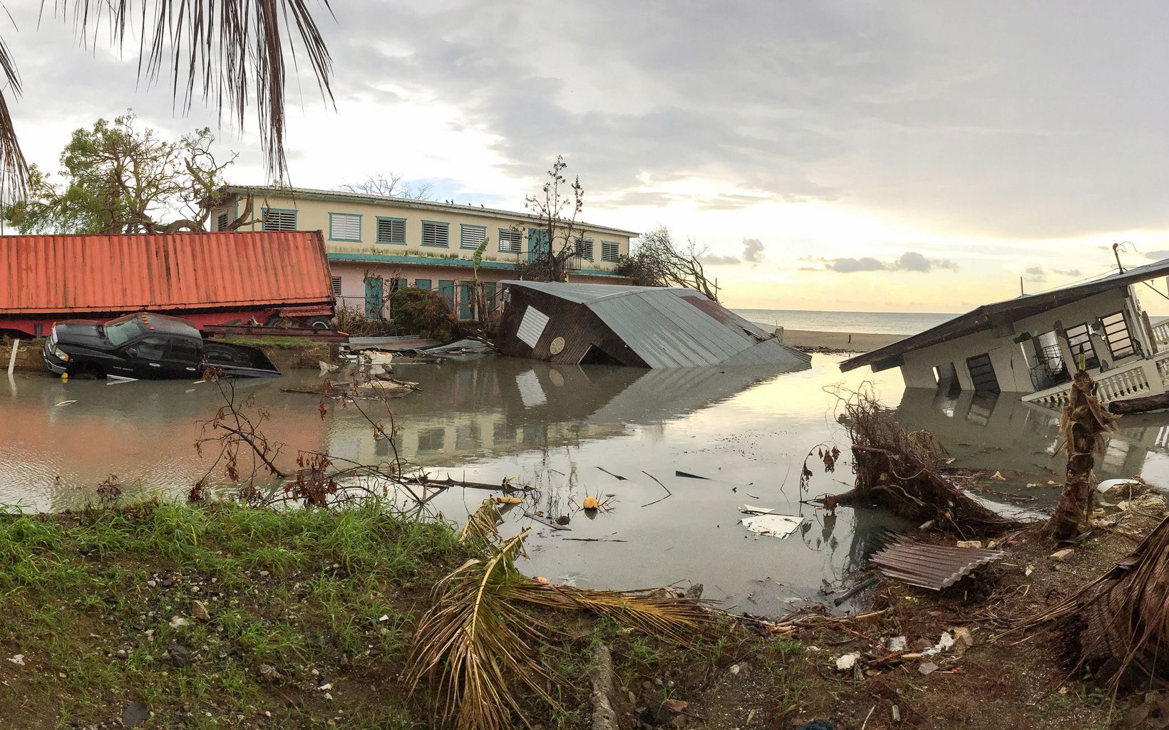Damaged homes in Puerto Rico sink in elevated waters after Hurricane Maria.