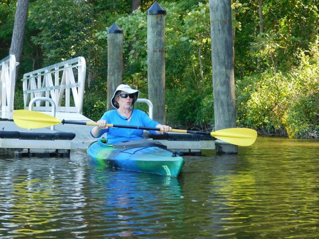Deborah Dalley Phillips paddles in a kayak in the water.