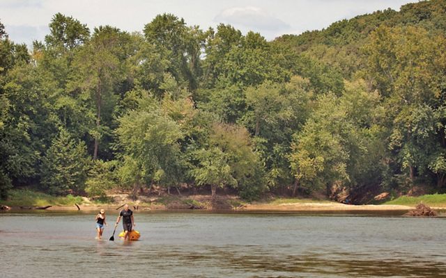 Kayakers portaging around a sandbar in the Missouri Meramec River, one of the longest free-flowing waterways providing key habitat protections in the face of climate change.