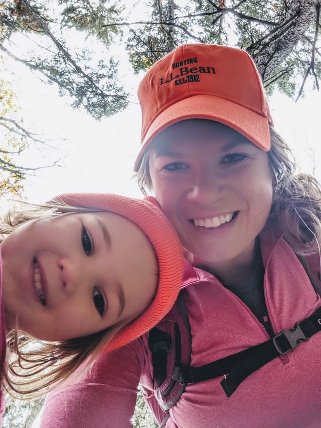 Molly Payne Wynne takes a selfie with her young daughter while exploring a forest.