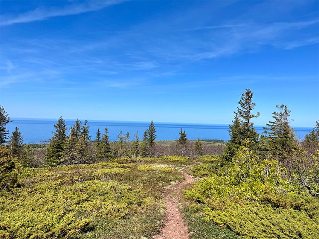 A trail at Helmut and Candis Stern Preserve at Mt. Baldy in Eagle Harbor, Michigan overlooks Lake Superior on a clear day. 