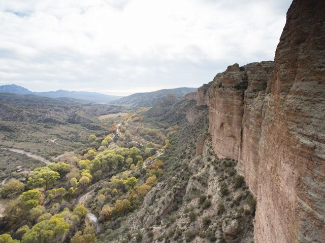 Canyon walls overlook a mountain range.