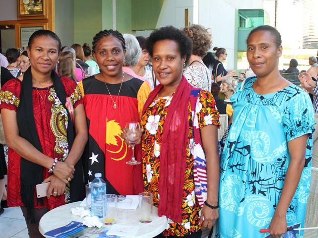 A group of 4 women stand together.