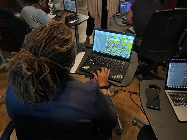 A woman using a computer to map green space. 