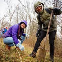 Two volunteers plant trees at Big Darby Headwaters Nature Preserve.