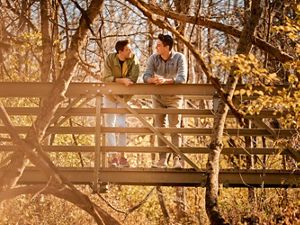 Chad Duplain stands with partner Matthew on bridge overlooking stream at Big Darby Headwaters Nature Preserve.