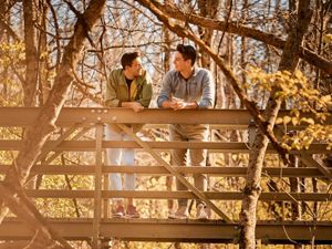 Chad Duplain stands with partner Matthew on bridge overlooking stream at Big Darby Headwaters Nature Preserve.