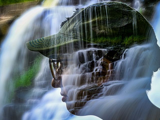 Double exposure of side profile of head against backdrop of waterfall.