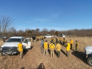 Group of fire practitioners preparing to conduct a controlled burn.