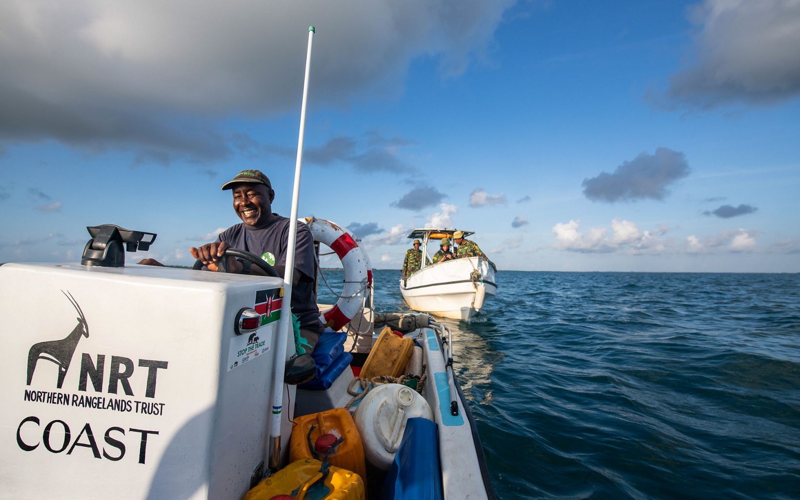 NRT boat driver Aboud Mohamed Omar (left) leads a group of NRT-trained Pate Marine Community Conservancy (PMCC) rangers on a patrol of the octopus closure area in Kenya.