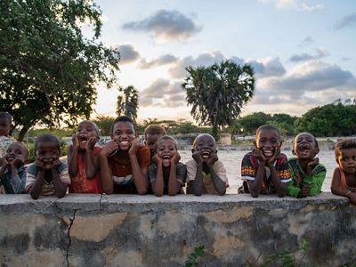 kids smile and laugh at camera