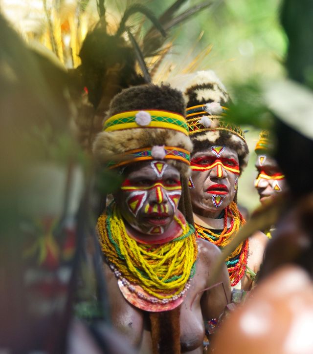 People dressed in cultural dress and makeup.