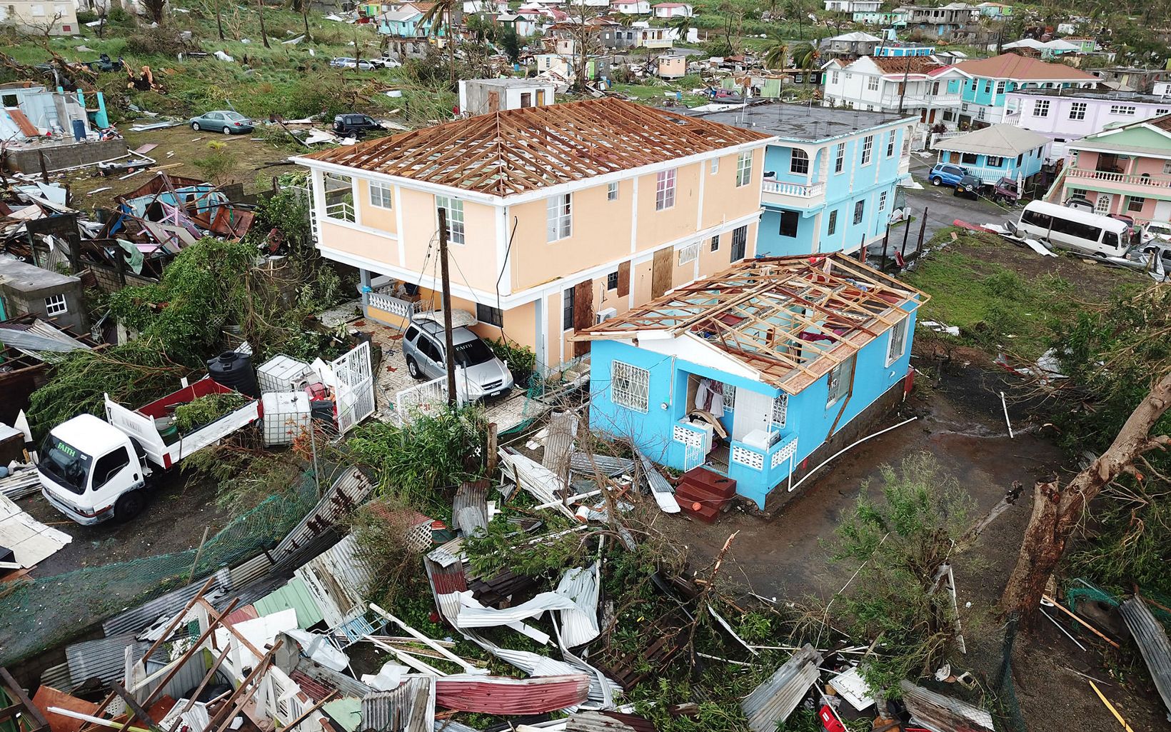 Houses missing roofs in Dominica after Hurricane Maria