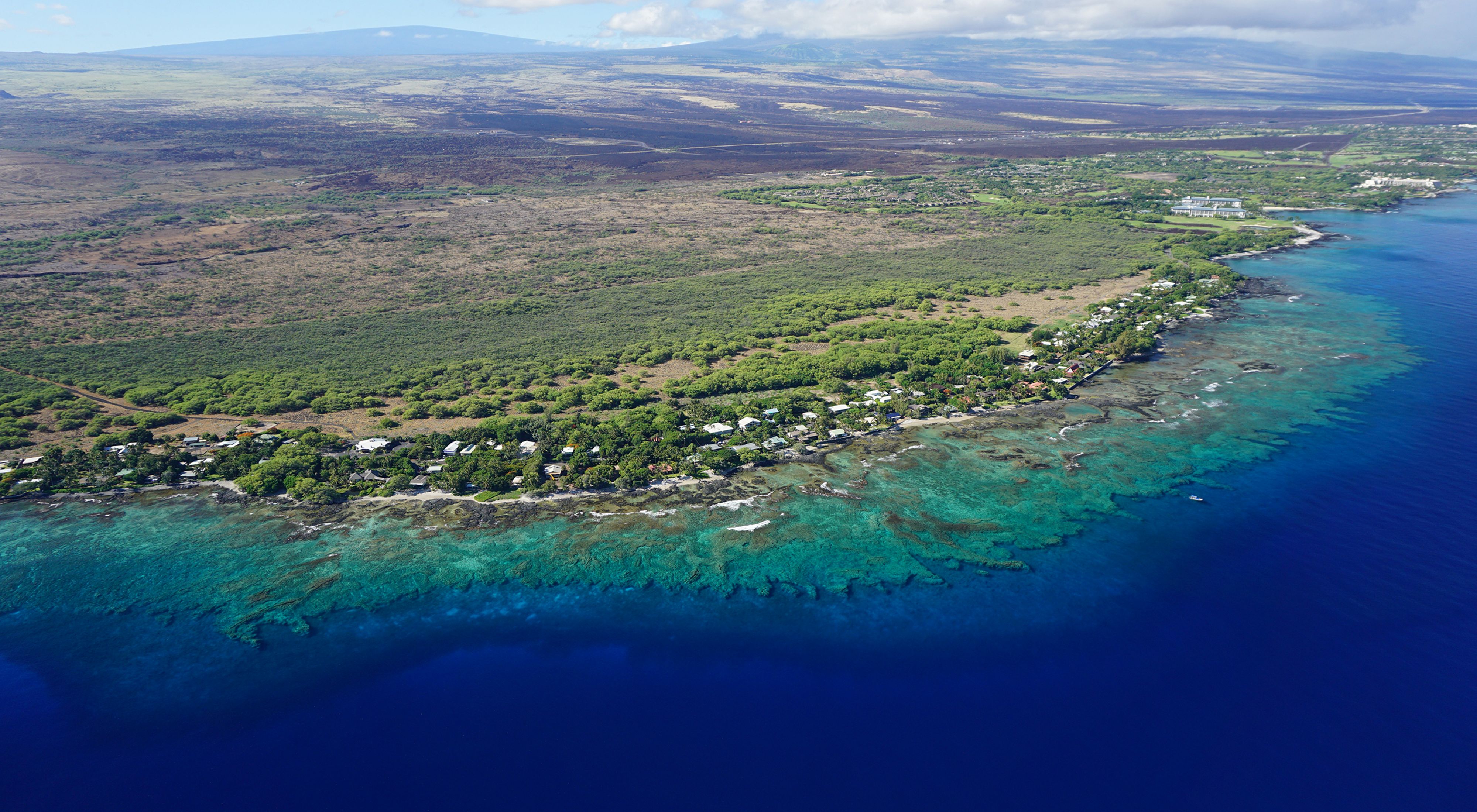 A coral reef spans the Puakō, Hawai‘i coastline.