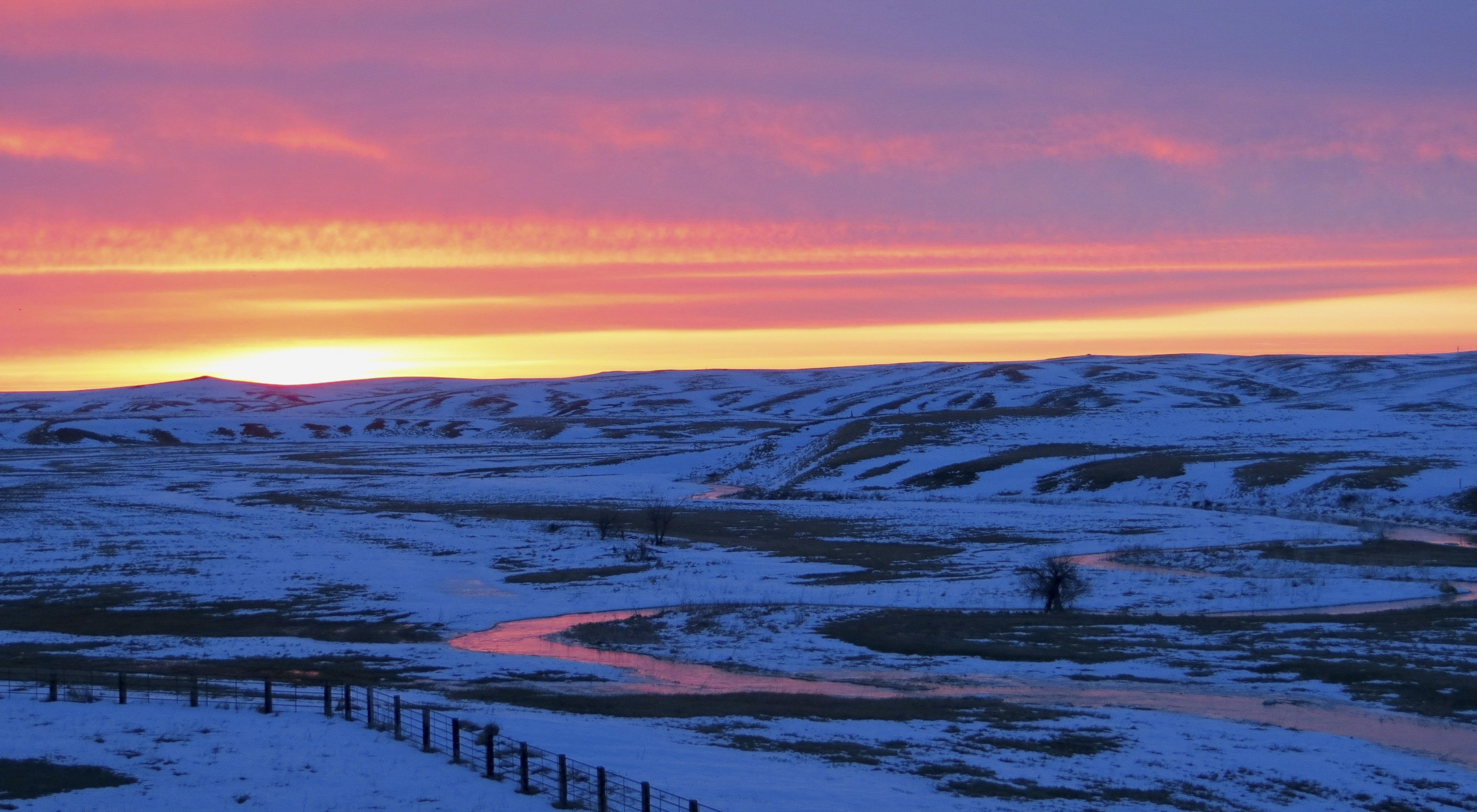 A sunset over the snow-covered South Dakota prairie.