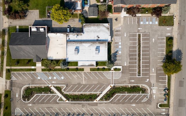 View from directly above showing a parking lot with more plantings between the rows of spots.