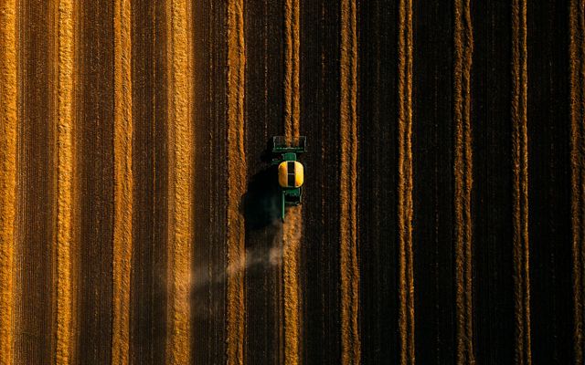 Aerial view of a tractor in a field.