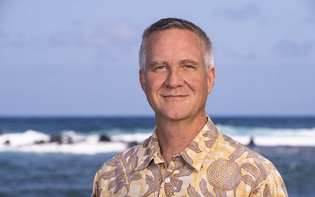 Headshot of Scott Crawford in front of the ocean.