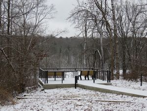 Snow covered overlook area with benches.