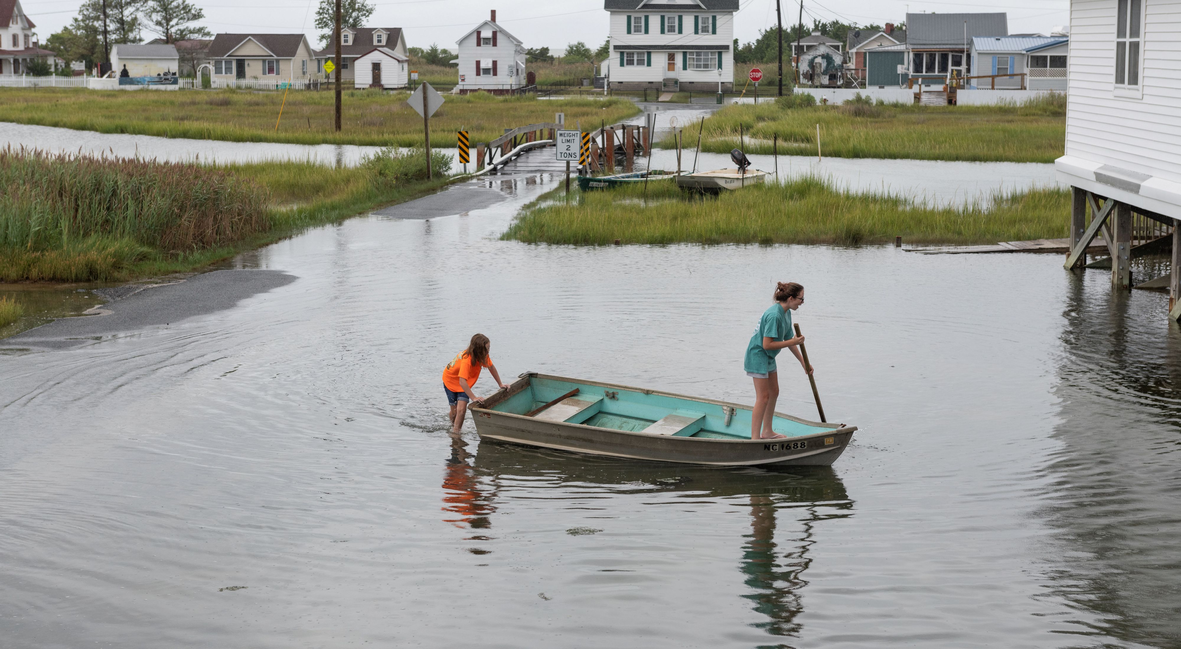 Two girls in a rowboat in a flooded Maryland town.