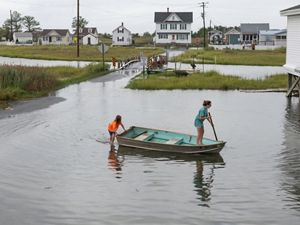Two girls in a rowboat in a flooded town in Maryland