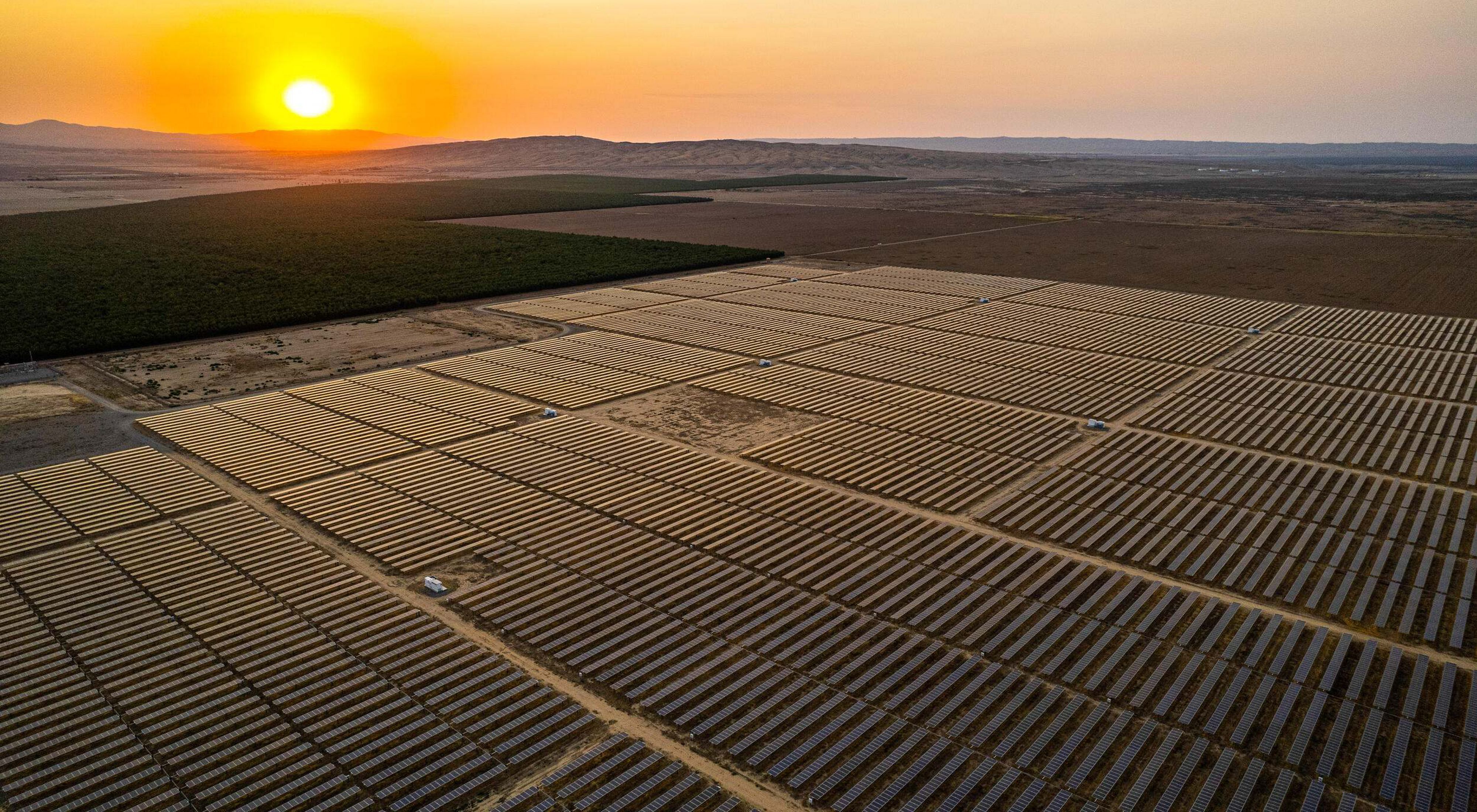Aerial image of solar array with sunset. 