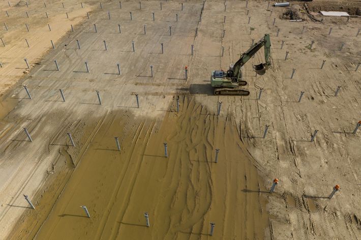 A large piece of construction equipment in an open field.