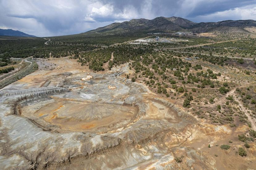 Disturbed mine lands in Nevada surrounded by desert and mountain landscape. 