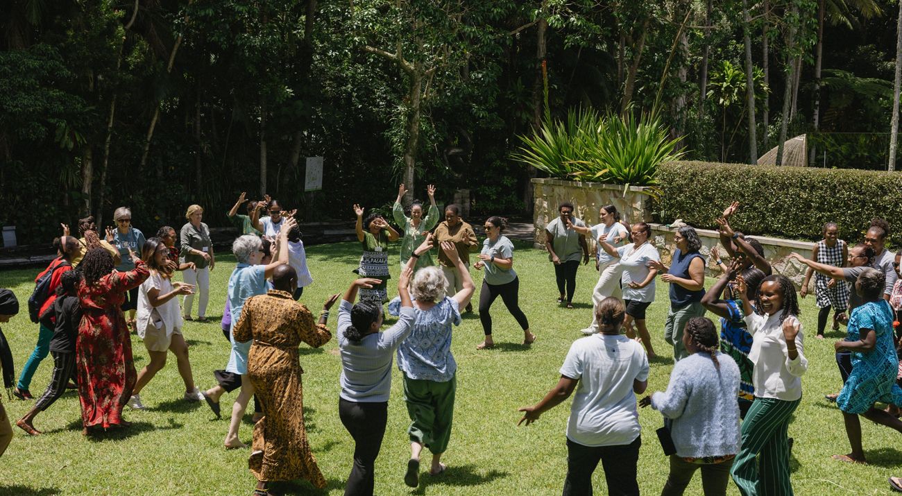A group of people participating in an energizer activity.