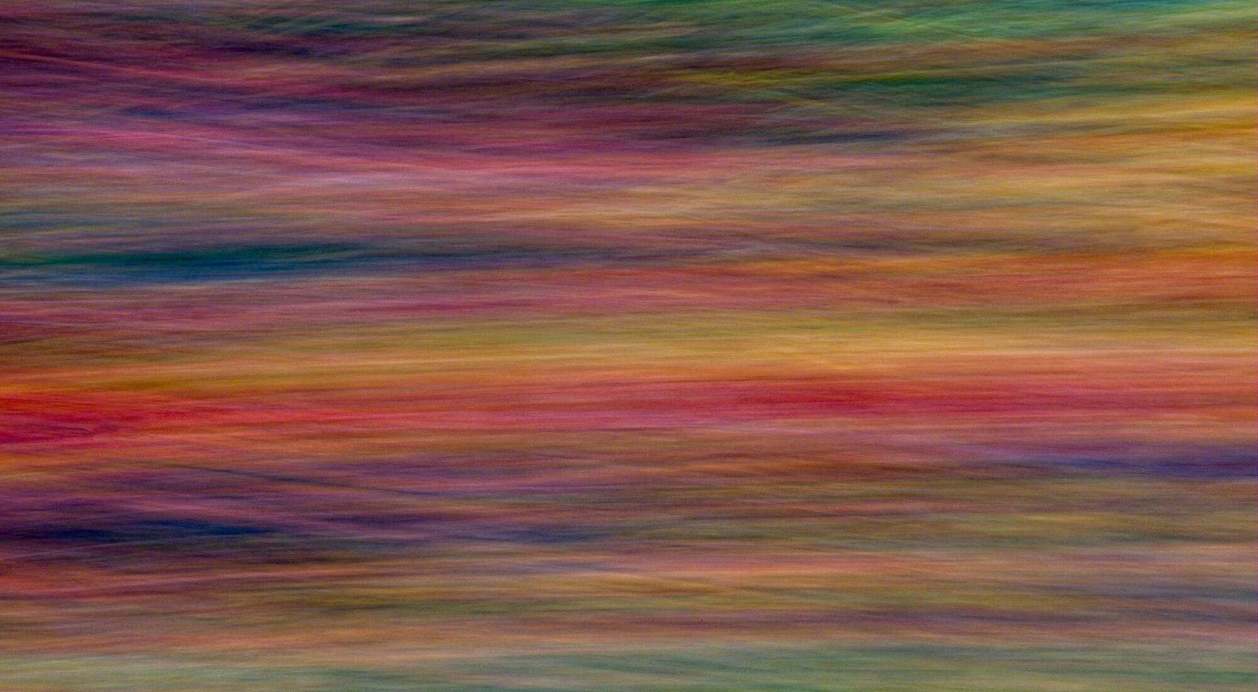 A horizontal blur of multiple colors.