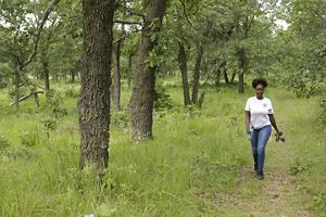 A person walking in a natural area.