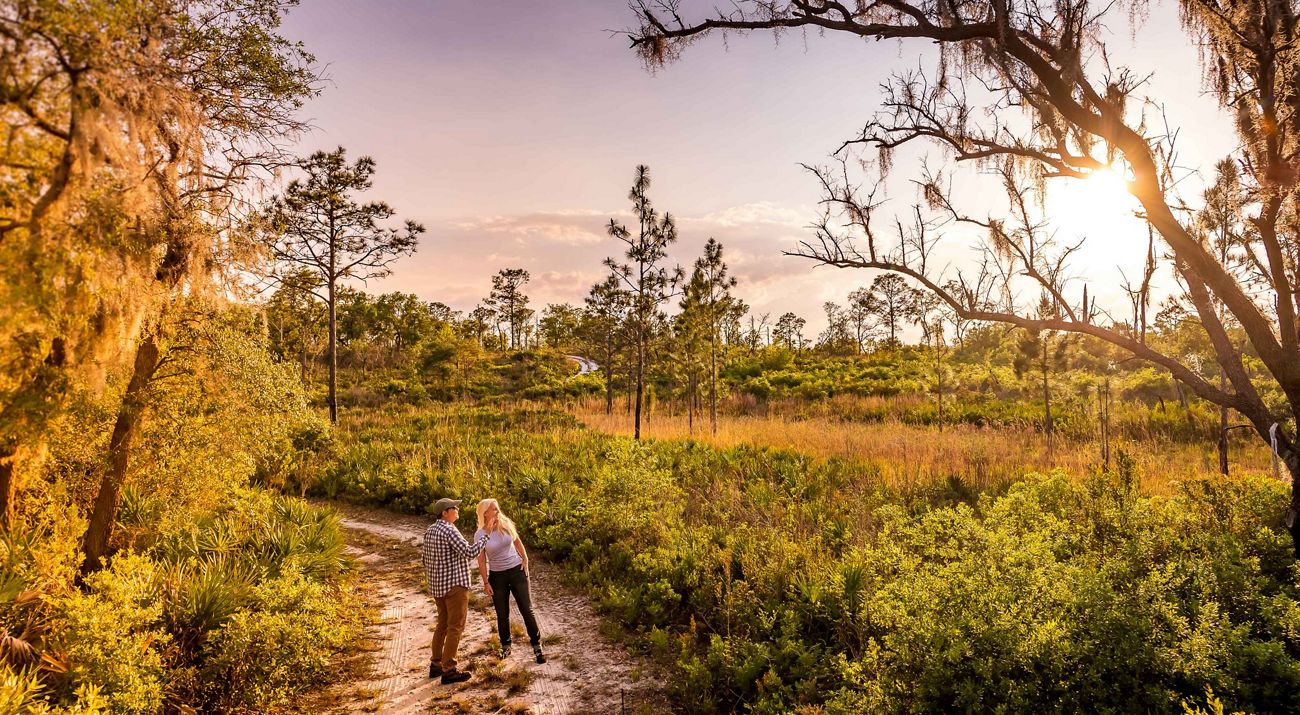 Two hikers explore Tiger Creek Preserve in Central Florida.