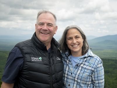 Tom Gorman and Kate Dempsey pose on a mountain top.
