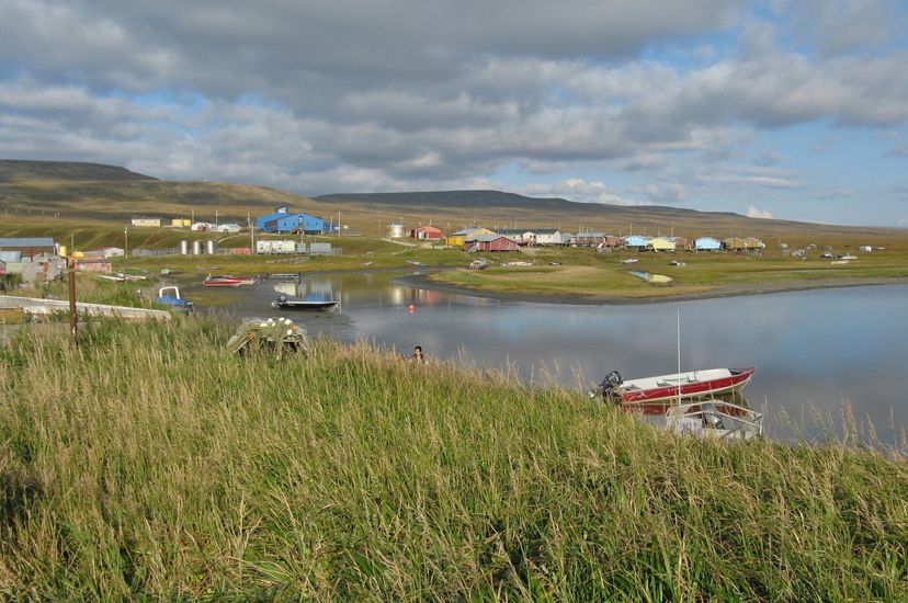 Scenic landscape view of a small fishing community on the edge of a body of water.