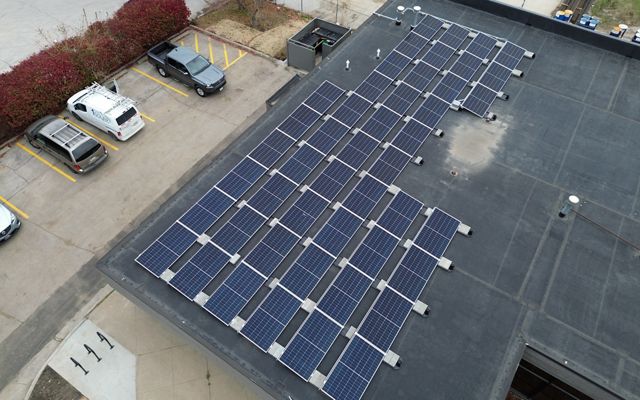 Aerial image of solar panels on the top of a building.