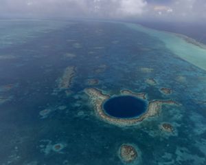 The Great Blue Hole is a circle of deep blue off the coast of Belize.