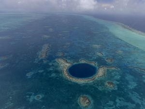 The Great Blue Hole is a circle of deep blue off the coast of Belize.
