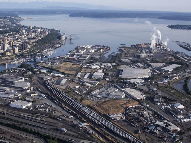Aerial view of a port with industrial buildings along its edges.