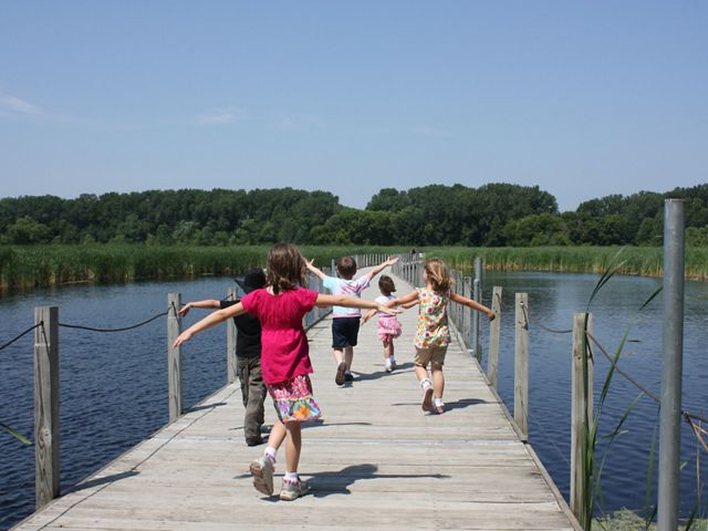 Kids running along the boardwalk at Wood Lake Nature Center.