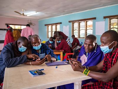 People in a classroom looking at mobile phones