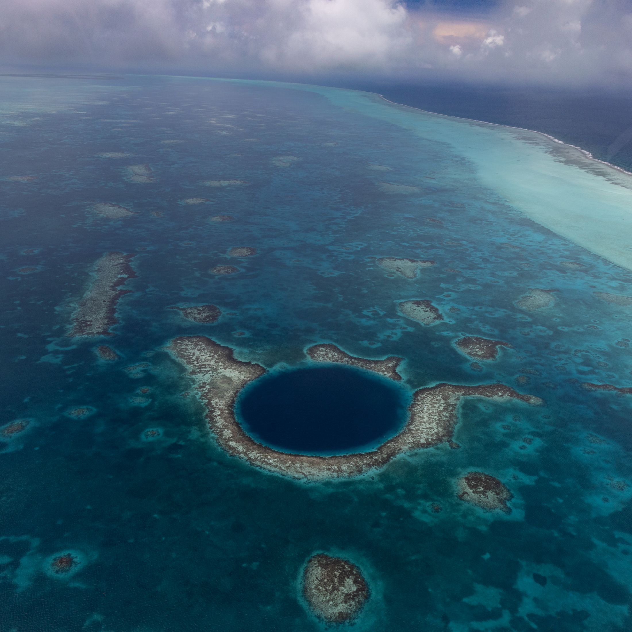 The Great Blue Hole is a circle of darker blue off the coast of Belize.