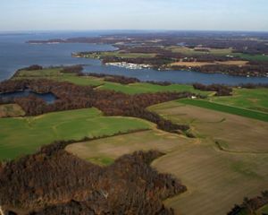 Aerial view of Chesapeake Bay with farmland beside it.