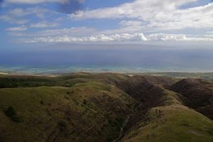Aerial view over Molokai of rugged mountains and coast. 