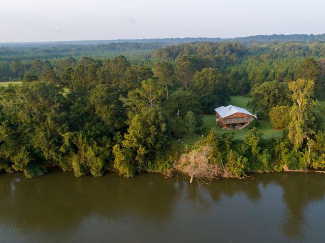 A home sits on the shores of the Alabama River.